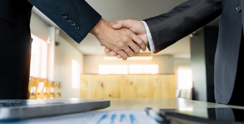 two-confident-business-man-shaking-hands-during-a-meeting-in-the-office-success-dealing-greeting-and-partner-concept